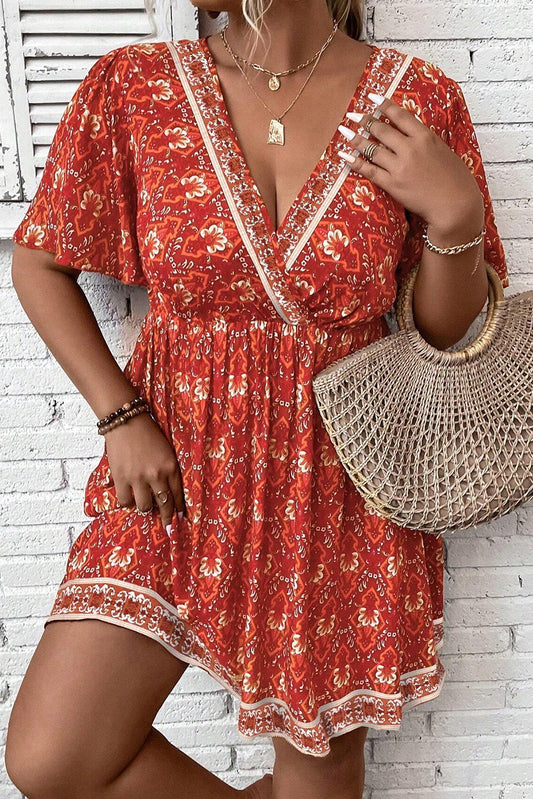 Plus Size Printed Surplice Neck Empire Waist Flowy Mini Dress