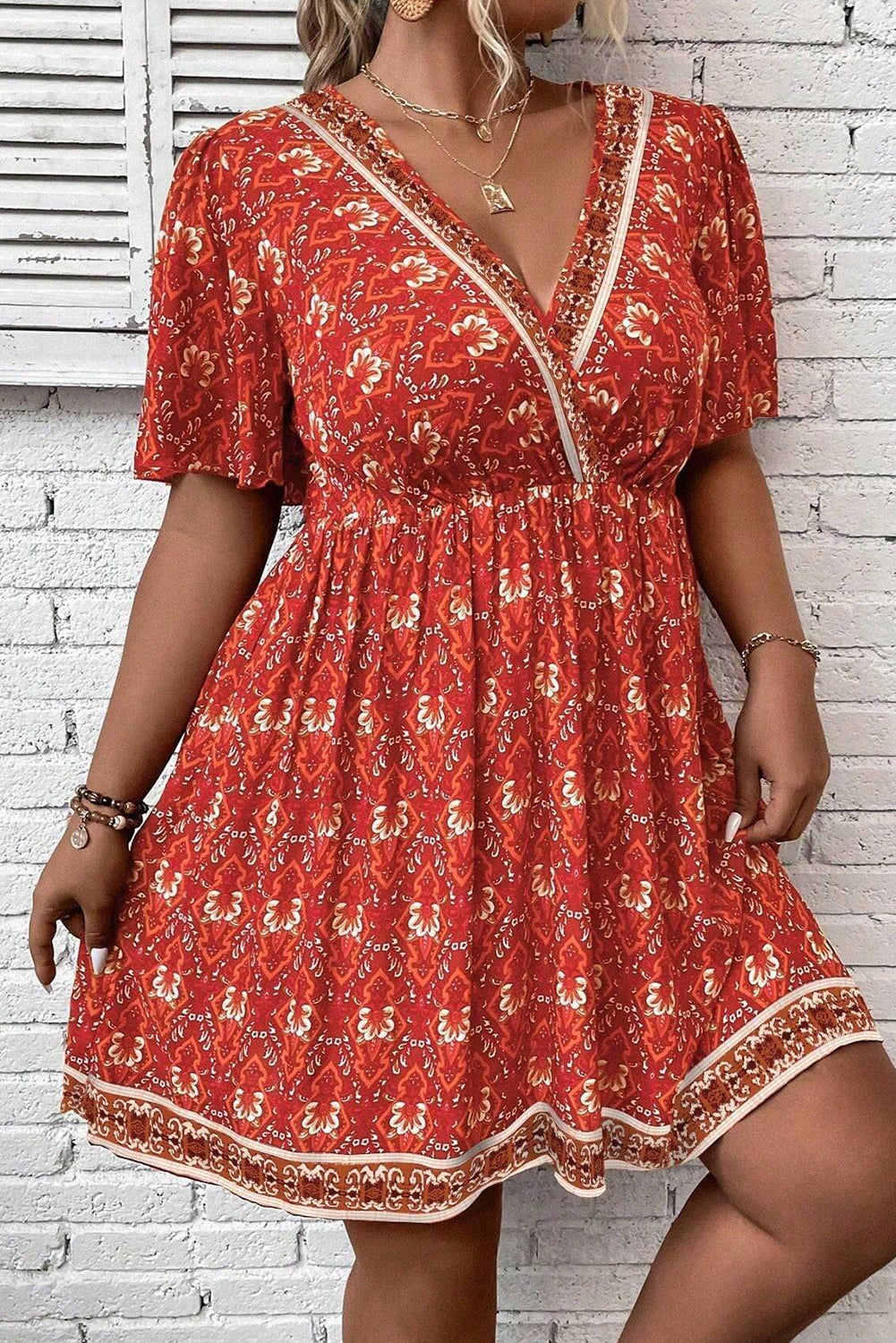 Plus Size Printed Surplice Neck Empire Waist Flowy Mini Dress