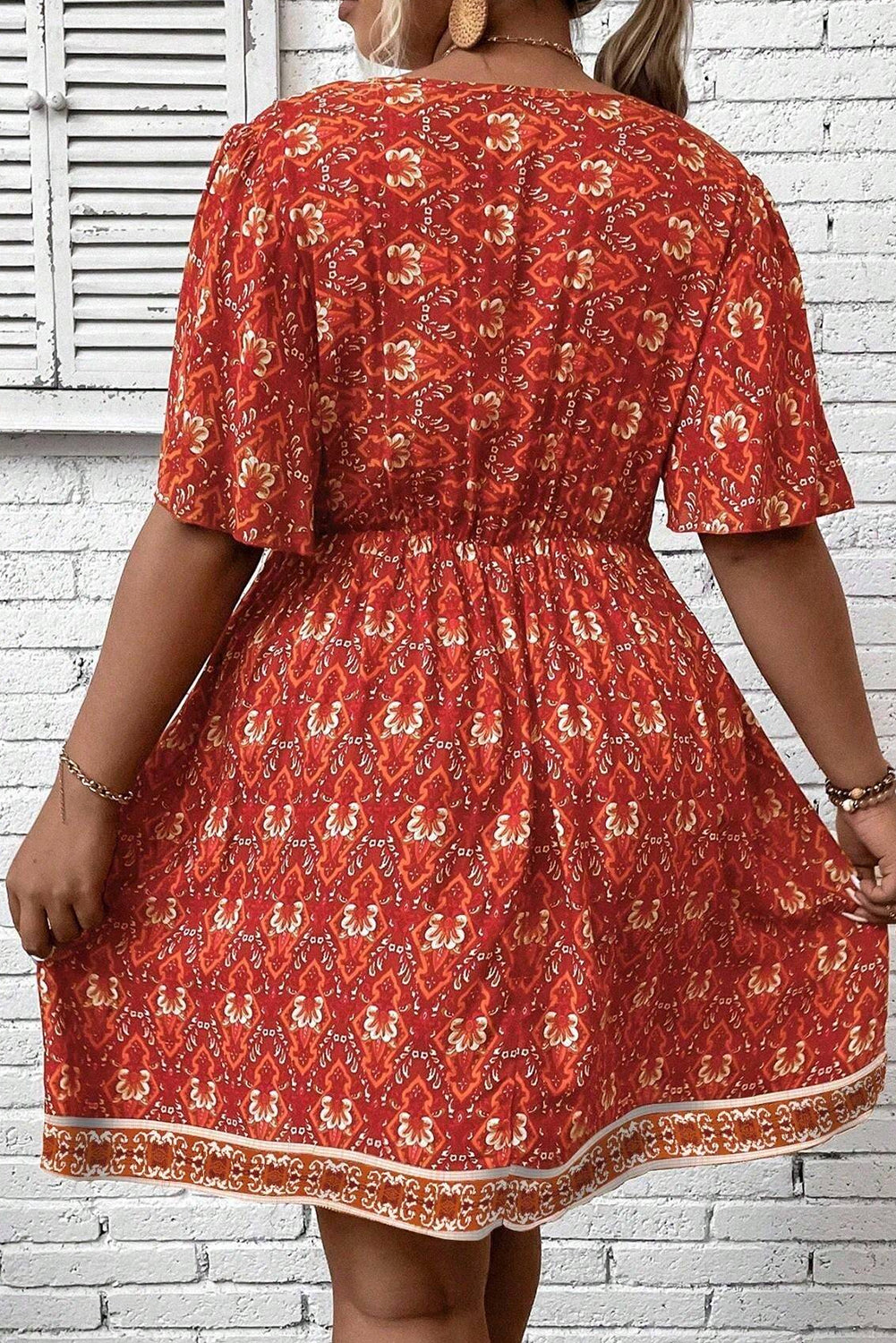 Plus Size Printed Surplice Neck Empire Waist Flowy Mini Dress